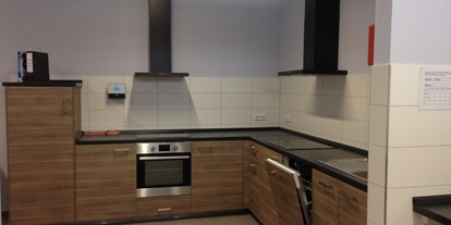 Reisemobilstellplatz - Reiten - Die moderne und großzügig gestaltete Küche bietet auch Sitzgelegenheiten für insgesamt 8 Personen. - Wohnmobilstellplatz am Noor